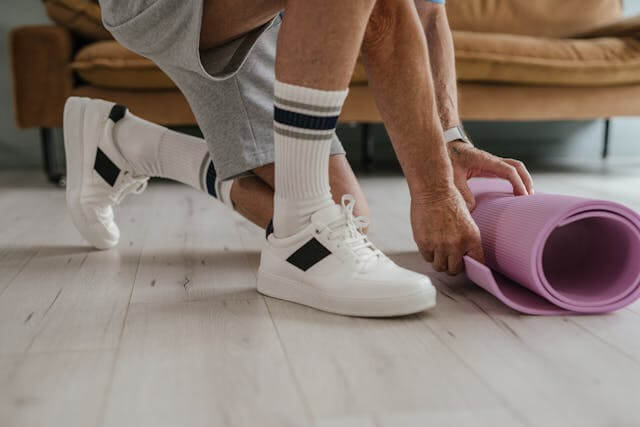 Man holding a yoga mat